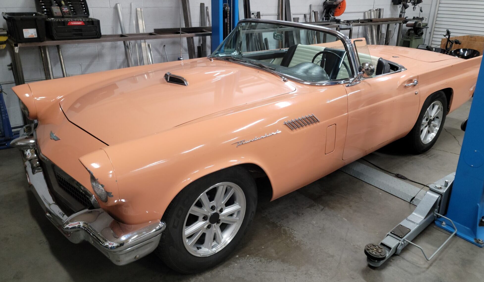 vintage pastel pink car parked in garage