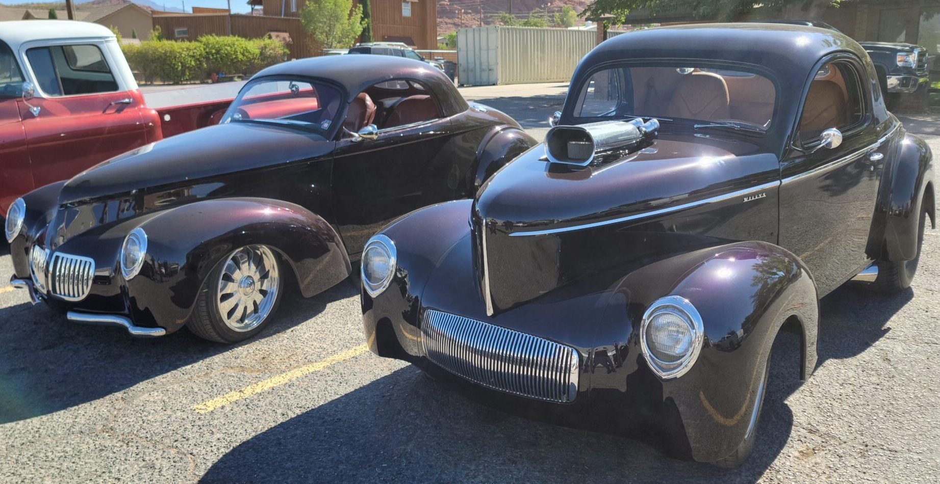 two black vintage cars parked