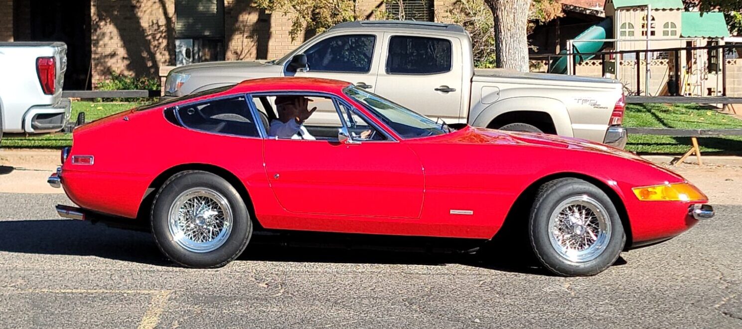 closeup red sports car with silver pickup