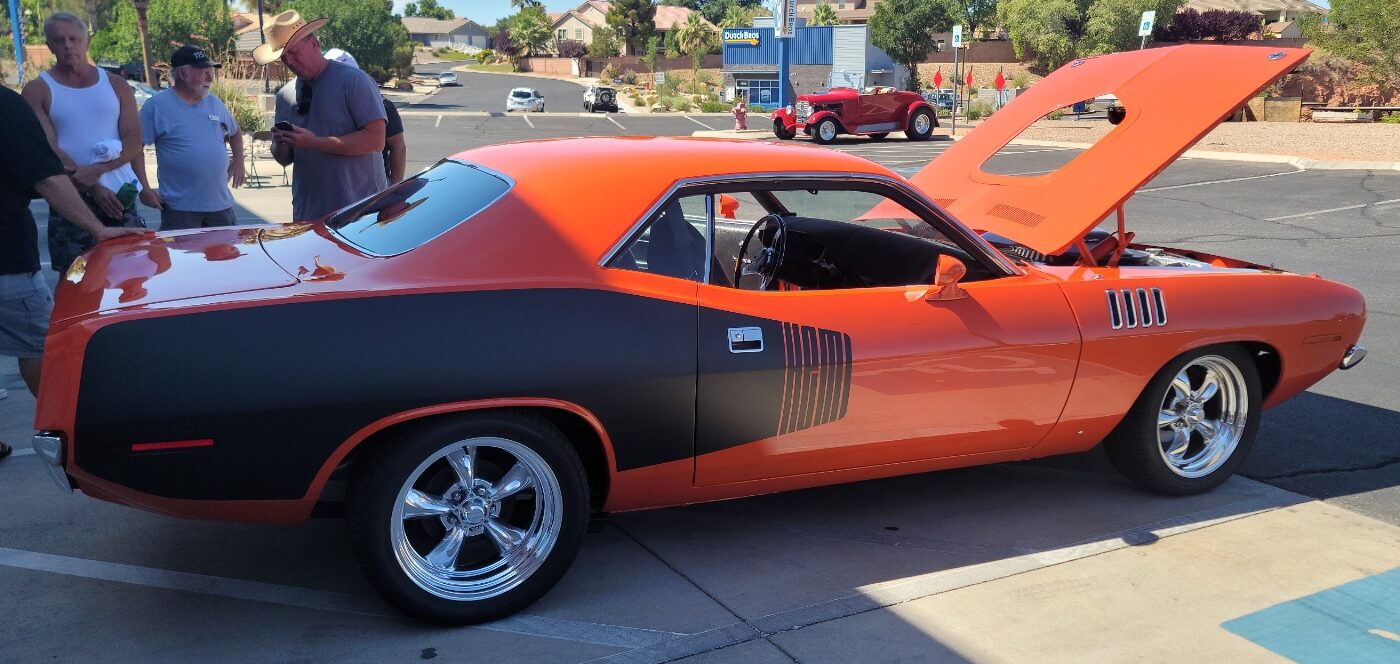 orange and black car in driveway