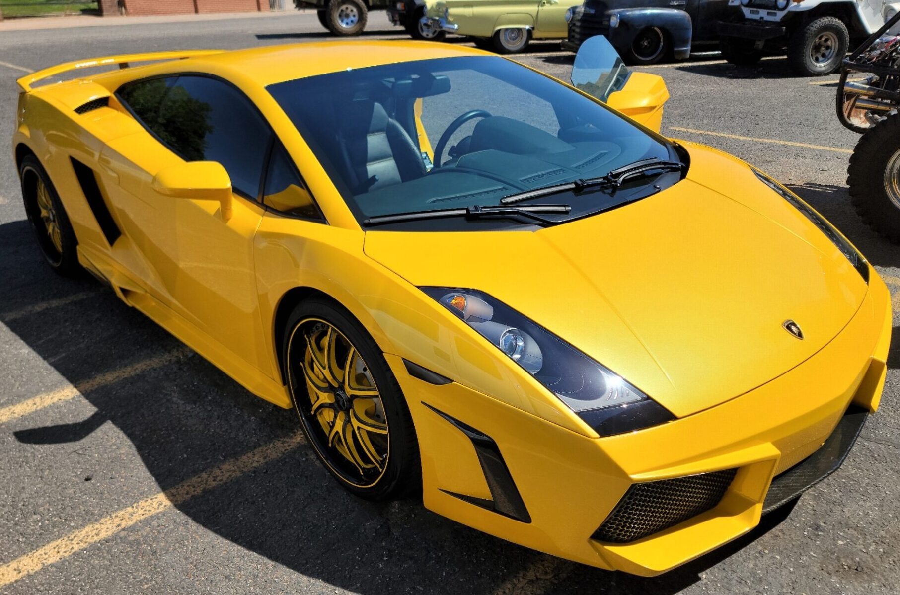 closeup yellow and black car in parking lot